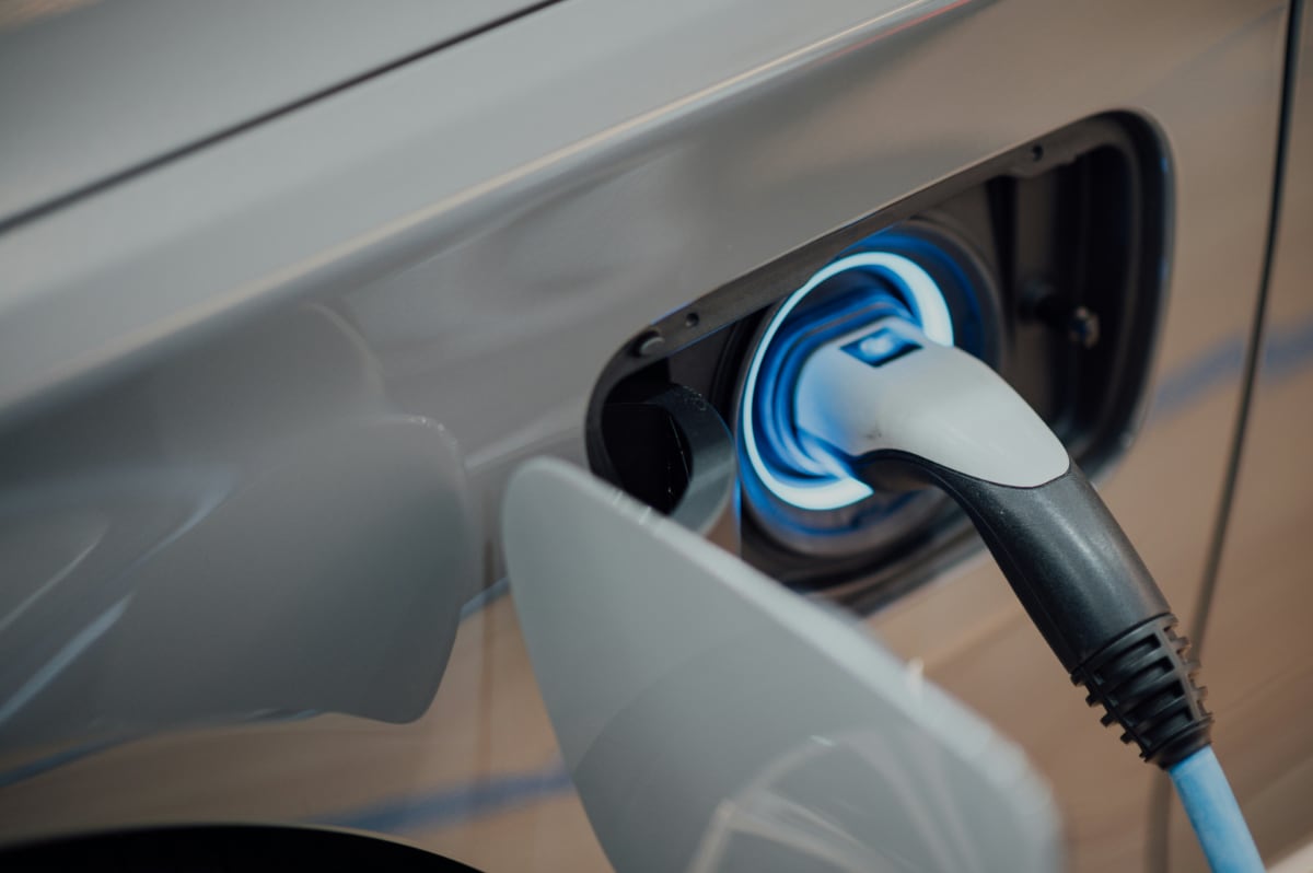 An ev charger plugged in to a car
